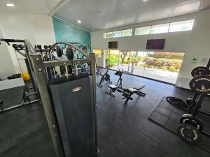a fitness room with a gym with tread machines at Punta Sal Suites & Bungalows Resort in Canoas de Punta Sal