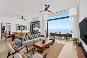 a living room with a couch and a table at Kove Samui in Koh Samui 