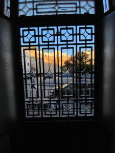 a window with a view of a sunset seen through it at Private room in the kasbah in Tangier