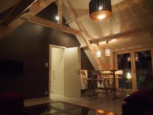 a dining room with a table and chairs at Archipel Holiday Cottage in Ellezelles