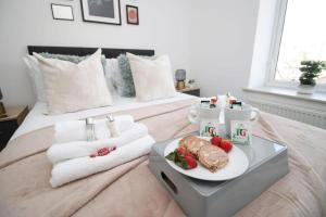 a hotel room with a plate of food on a bed at Old Market House 3 BR close to town centre in Newport