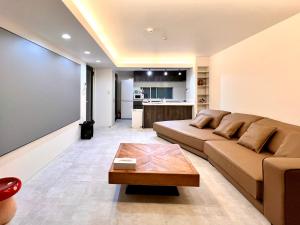 a living room with a couch and a coffee table at LoveTokyo Maisonette Terrace in Tokyo