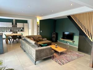 a living room with a couch and a table at Happy Duplex in Jalhay