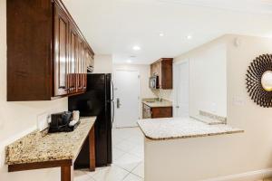 uma cozinha com armários de madeira e uma bancada em Dunes King Room Oceanfront Views em Pawleys Island