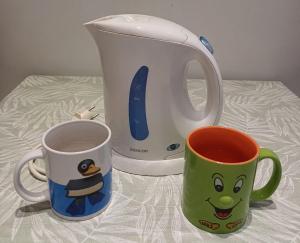 two coffee mugs sitting on a table next to a toaster at Ca' delle Furlane in Venice