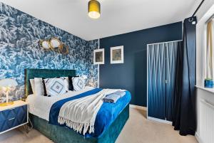 a blue bedroom with a bed and blue walls at Stunning Manchester House - Garden in Manchester