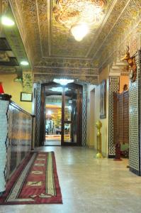 a hallway of a building with a tile ceiling at Hotel Lixus in Nador