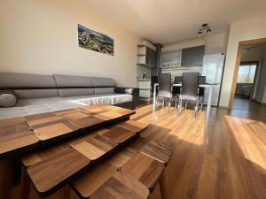 a living room with a couch and tables and chairs at Nataly Homes 2 in Veliko Tŭrnovo