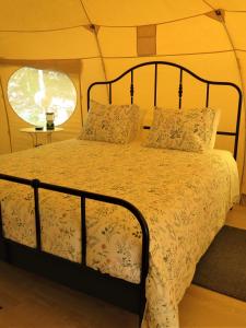 a bedroom with a bed in a tent at Wild Glamping Portugal a glamorous camping to relax in Viana do Castelo in Viana do Castelo