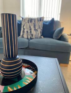 a vase sitting on a table in a living room at Temper Mill 3 BR Garden & FREE parking in Newport