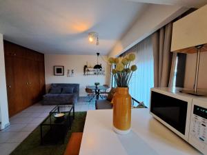 a kitchen and living room with a couch and a table at BC Studios in Blankenberge