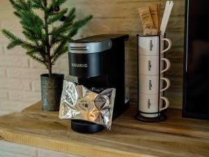 a shelf with two coffee cups and a christmas tree at Stonegate Lodge W Pool & Outdoor Firepits Room #201 in Eureka Springs