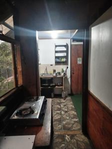 a kitchen with a stove and a sink in it at Mi Casa Tica Backpackers in Monteverde Costa Rica