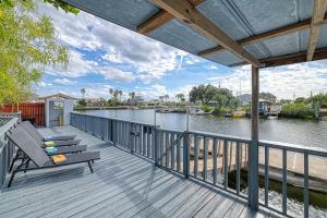 a deck with a bench and a view of a river at 5 Bed/3 Bath Waterfront / Pool in Hernando Beach