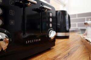 a toaster oven sitting on top of a counter at Summerlays 2 BR apartment in the centre of Bath in Bath