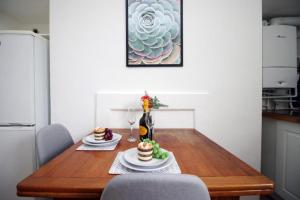 a dining room table with two cakes and wine glasses at Summerlays 2 BR apartment in the centre of Bath in Bath