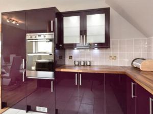 a kitchen with wooden counter tops and stainless steel appliances at Glen View Lodge in Inverness