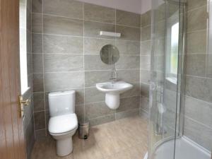 a bathroom with a toilet and a sink and a shower at Glen View Lodge in Inverness +22 photos
