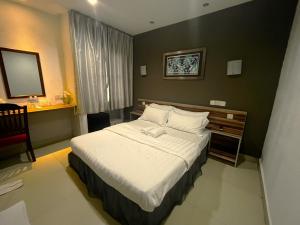 a hotel room with a bed and a mirror at One Avenue Hotel Balakong in Seri Kembangan