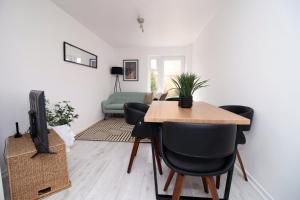 a living room with a table and chairs and a couch at 4 BR with FREE on street parking in Bristol