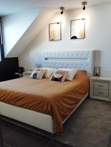 a bedroom with a large bed with two mirrors on the wall at Sweetnest by home in Waterloo