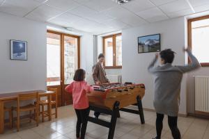 a group of people playing a game with a table at Chalet du Bon Air in Peisey-Nancroix