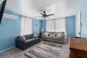a living room with two couches and a ceiling fan at Unit 2 at The Sunflower in Wildwood in Wildwood
