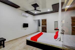 a bedroom with a large bed with a red blanket at OYO Flagship Hotel Galaxy in Nagpur