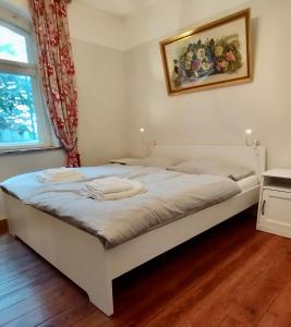 a white bed in a room with a window at "Haus Seegang" für Naturliebhaber, strandnah, ruhig, mit großem Garten in Pepelow