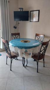 a table with two chairs and a table with a blue top at Stay A While in Saint Philip
