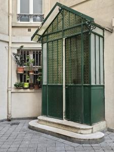 a green door on the side of a building at Orsay - Beautiful flat in elegant part of Paris in Paris