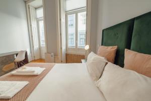 1 dormitorio con 1 cama blanca grande y cabecero verde en Formosa Deluxe by Hosty en Oporto