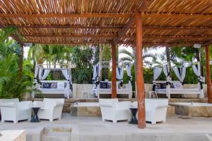 a set up for a wedding under a pergola at Oh! Cancun - The Urban Oasis & beach Club in Cancún