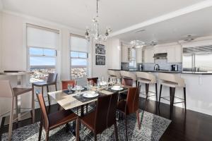 an open kitchen and dining room with a table and chairs at Luxury Living at The Grand in Wildwood