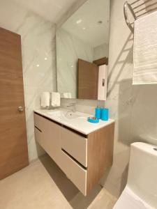 a bathroom with a sink and a mirror at NOVAPARK HOTEL in Guayaquil