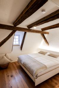 a bedroom with a large bed with wooden beams at Faust-Appartements 