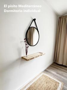 a mirror on a wall in a room at El pisito mediterráneo in Melilla +19 photos