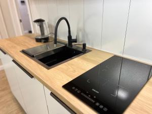 a kitchen with a sink and a counter top at Элитная квартира возле площади in Shymkent +2 photos