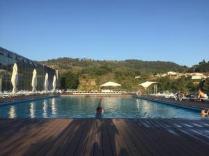 a person is in the water in a swimming pool at Casa dos Limões in Arcos de Valdevez
