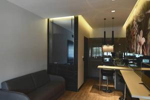 a living room with a couch and a kitchen at Avenue Luxury Apartments in Alexandroupoli