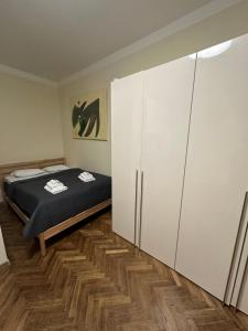 a bedroom with a bed and a large closet at DATRI Petite Suite 10 in Vienna
