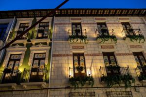 a building with potted plants on the side of it at Luxury Rosetti 24 in Novelda