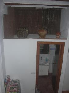 a small bathroom with a sink and a mirror at Casa rural Foreset in Alfara de Carles