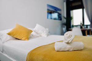 a white bed with a towel on top of it at Marina Suites Tenerife in Puerto de la Cruz
