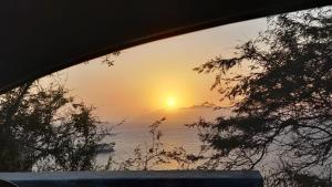 a view of a sunset from a car window at Chez Leonilde in São Filipe