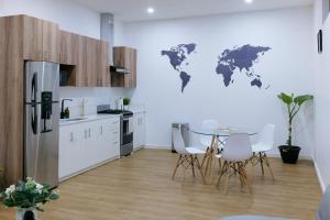 a kitchen with a table and a world map on the wall at Casa Valencia 5 in Santa Elena