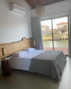 ブジオスにあるCasa de Luxo Aretêのベッドルーム1室(ベッド1台、大きな窓付)
