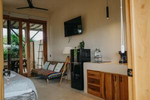 a kitchen with a refrigerator and a couch in a room at Holbox Deluxe Apartments in Holbox Island