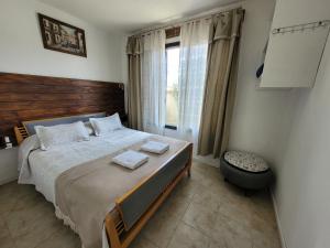 Un pat sau paturi într-o cameră la Cabañas "El Ancla"