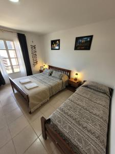 Postel nebo postele na pokoji v ubytování Cabañas "El Ancla"